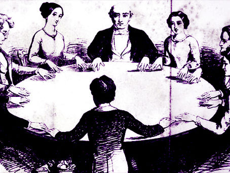 people gathered at table for a seance