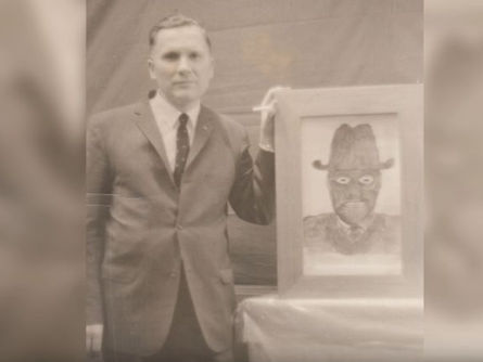 Image of man holding illustration of a real life man in black