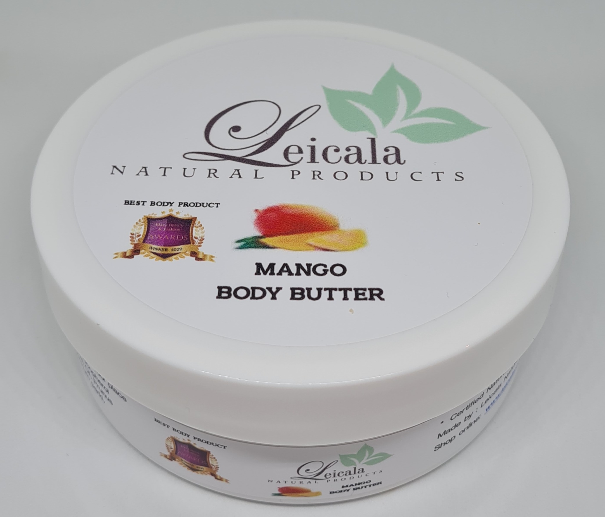 A luscious swirl of creamy mango body butter on a minimalist wooden surface.