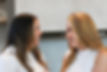 Two women sharing a supportive, eye-to-eye gaze, symbolizing a strong and empowering relationship built on trust and understanding.