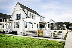 The Saltmarsh Cottage 312 is a coastal modern farmhouse home plan with 4 beds, 3.5 baths, open living, covered porch, and a private first-floor primary suite.