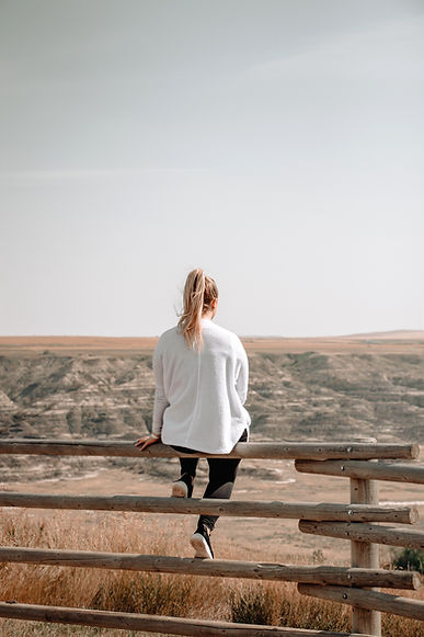 woman sitting on brown wooden railings_edited.jpg