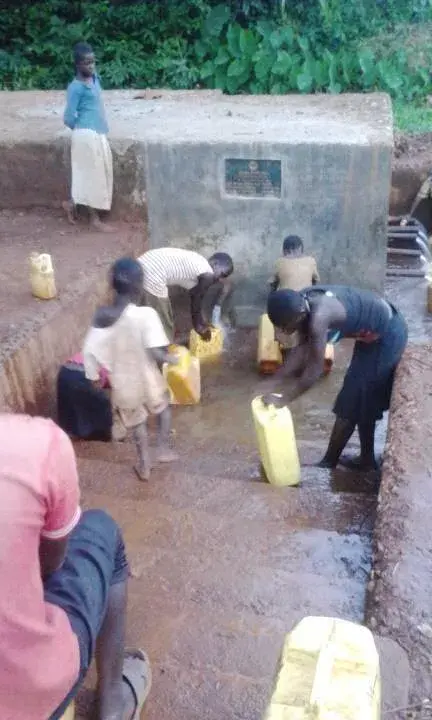 Children and adults building the orphanage together from the ground up