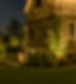 at dusk, landscape lighting on trees and home