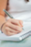 hand-holding-pen-notebook.jpg