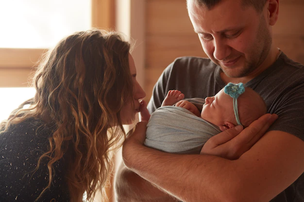 mother-father-embracing-their-daughter_8353-7860.webp