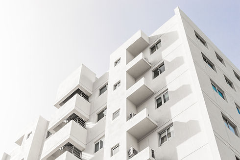 low-angle-shot-facade-white-modern-building-blue-clear-sky.jpg
