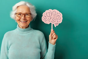 senior-woman-holding-brain-cutout-smiling-happily-against-teal-background.jpg
