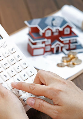 female-hand-operating-calculator-front-villa-house-model.jpg