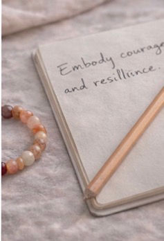 fire quartz bracelet on natural linen by an open journal