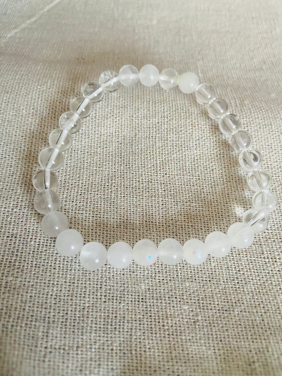 Thumbnail: new phase crystal bracelet on neutral linen cloth