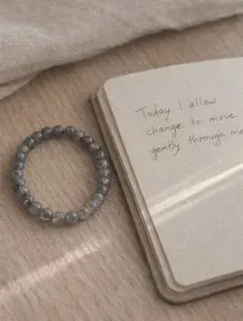 Miniatura: labradorite & moonstone bracelet sitting on wooden table next to an open journal
