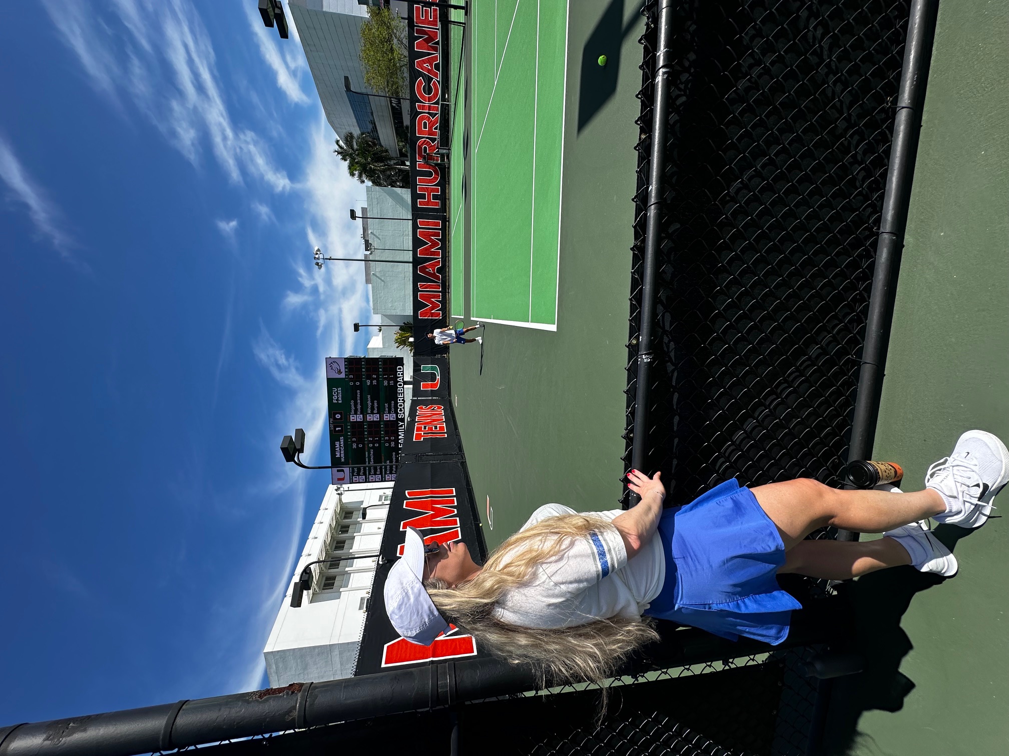 Mariana Correa observing a tennis match as team captain