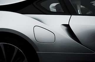 A modern sports car with a streamlined body and bold front grille, emphasizing speed and power.