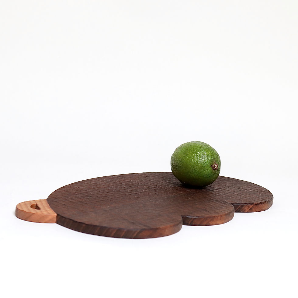 dark brown ebonized cutting board with whittling mark front view