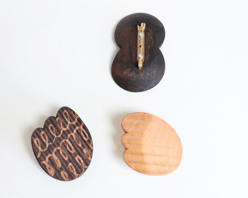 Thumbnail: wooden brooch in natural wood color and ebonized dark color front view