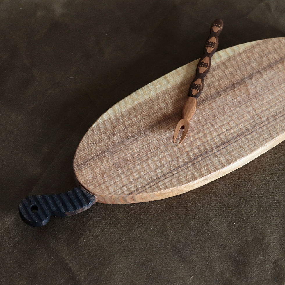 Thumbnail: This particular piece features the asymmetrical tear drop scoop, uniquely sculpted end with a hole for hanging. Ebonized with