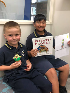 Students with the book The Potato People by Pamela Allen