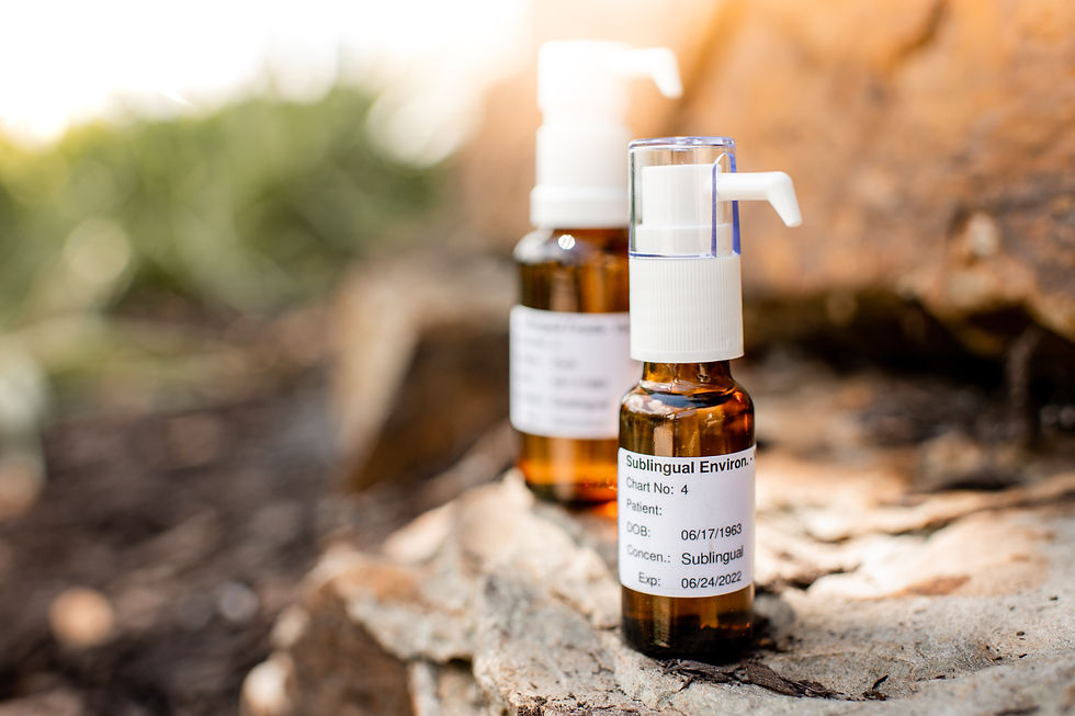 Two amber spray bottles on rocks outdoors