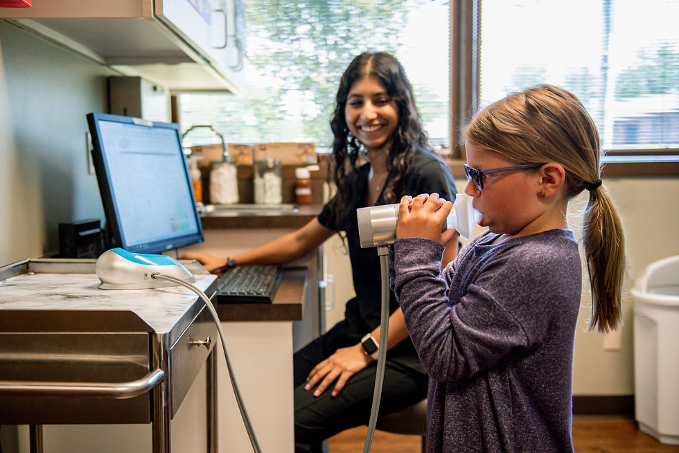 Young girl taking a spirometry test with a clinician
