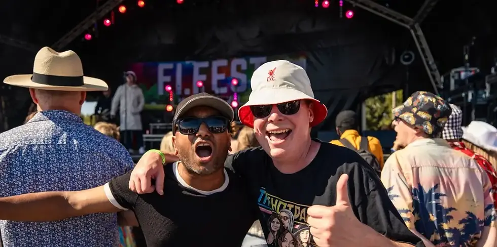 Two festival-goers giving a thumbs up