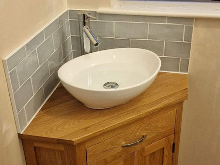 Removed old sink and fitted new one.
Tiled above the sink.