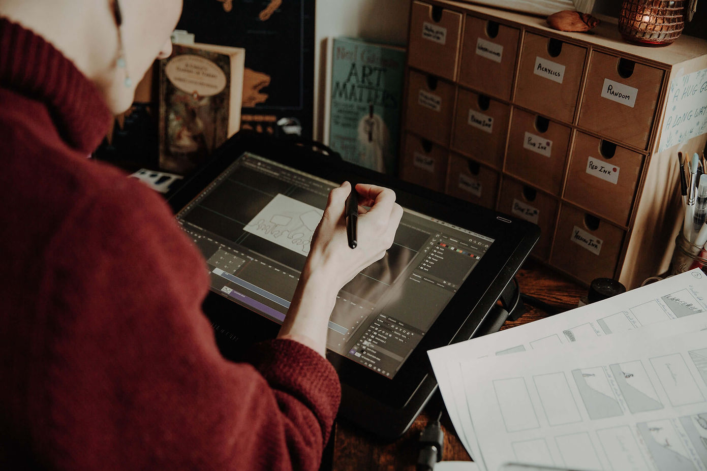 Johanna Gousset, professional animator working at her desk with a Wacom tablet, creating hand-drawn animations for a music video.
