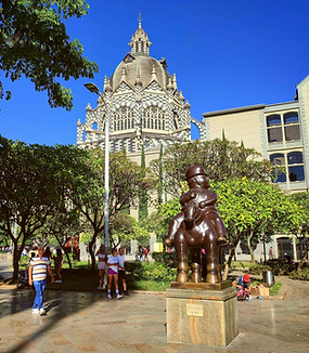 Botero sculpture in Plaza Botero with the Palace of Culture in Medellín, Colombia.