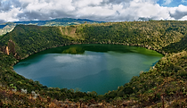 Laguna de Guatavita surrounded by green Andean mountains near Bogotá, Colombia.