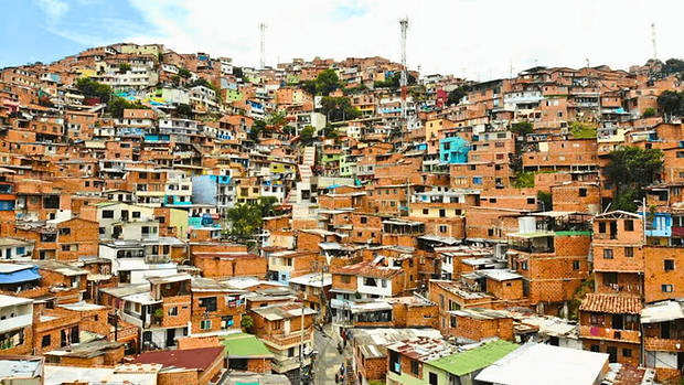Hillside neighborhood in Comuna 13, Medellín, showing colorful homes and urban transformation in Colombia.