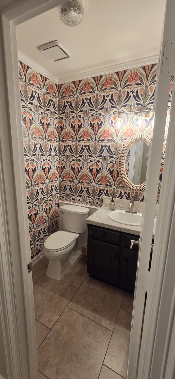 Graphic Floral Powder Bathroom. Colorful artful wallpaper wrapping a compact powder bathroom.