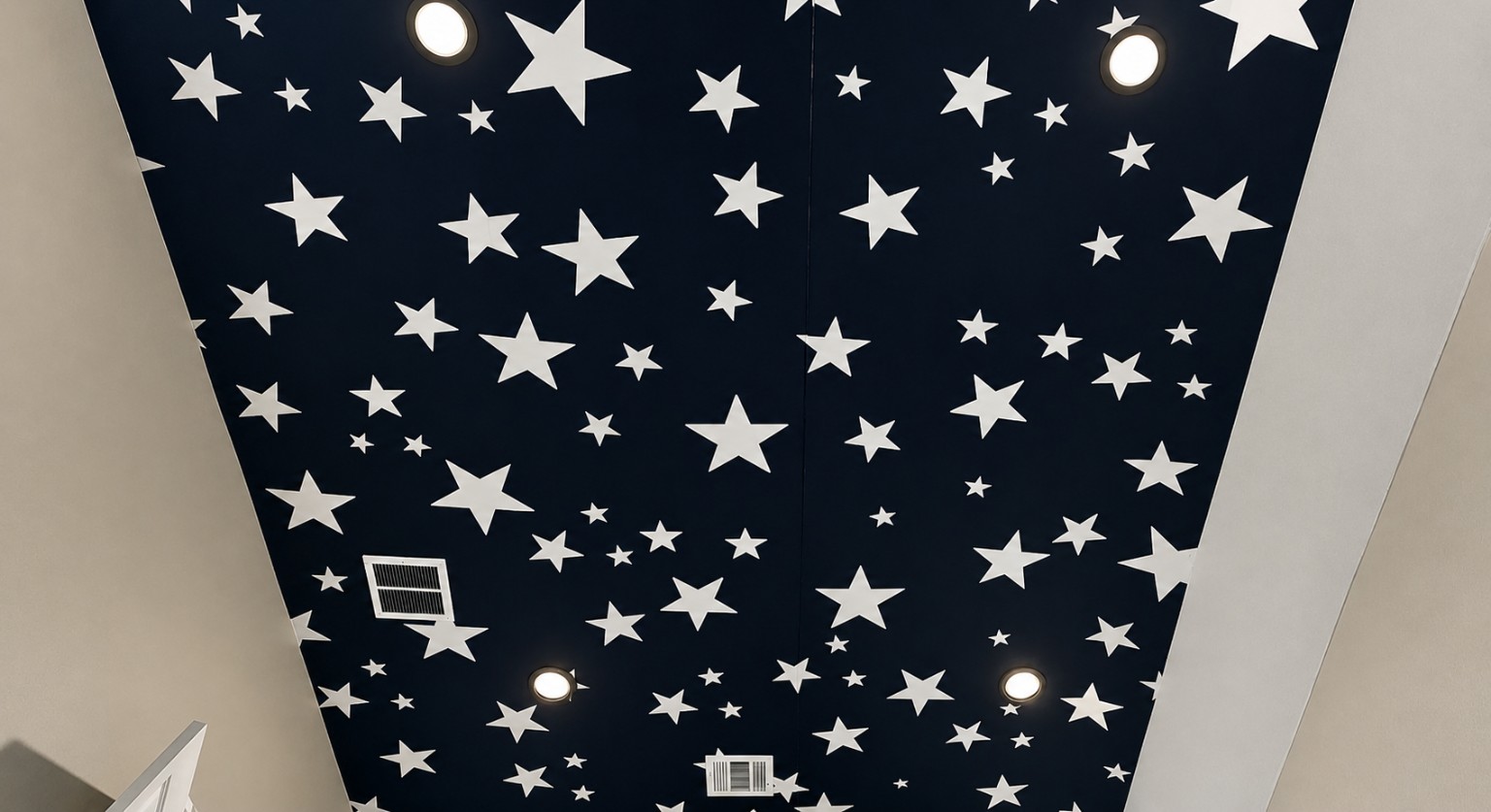 Starry Wallpaper Ceiling. Deep navy ceiling wallpaper featuring scattered white stars.