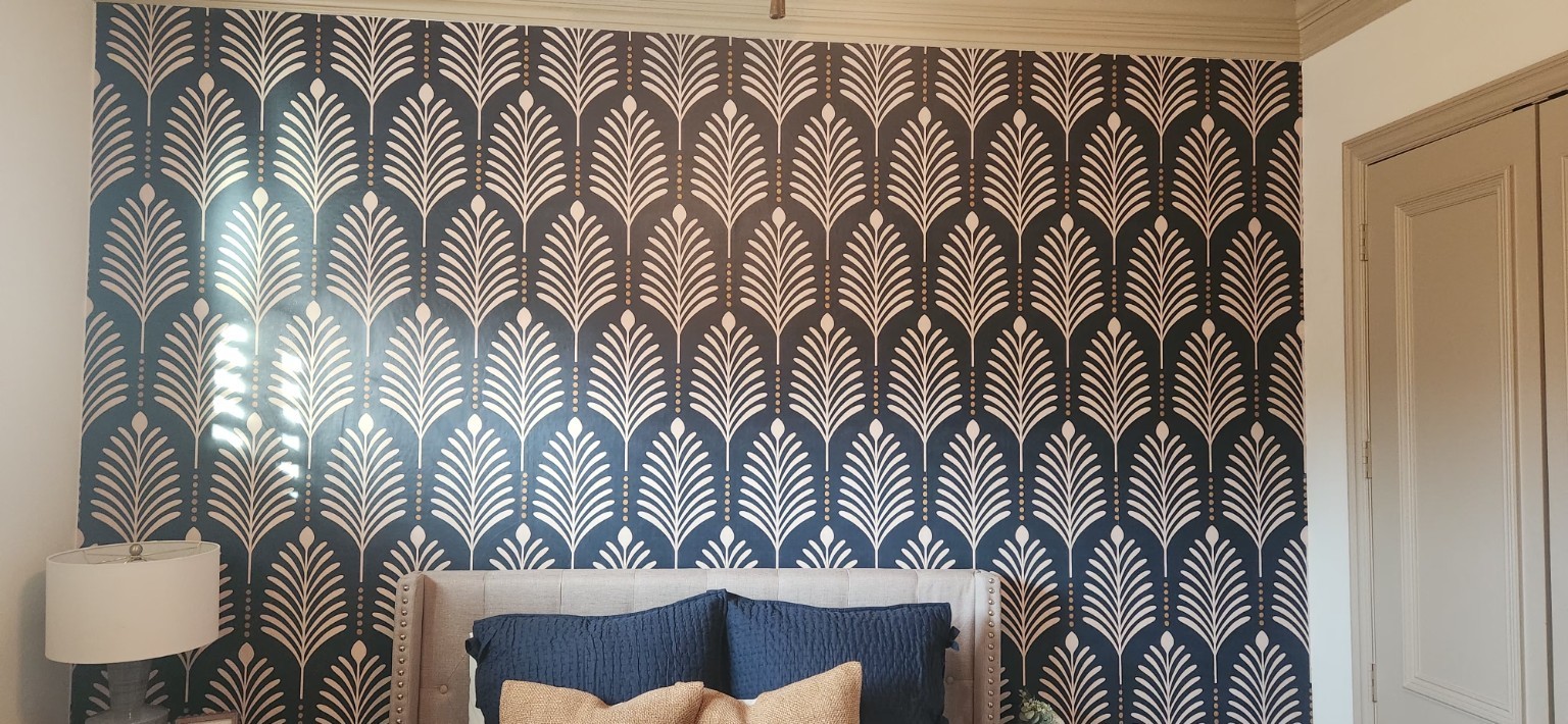 Navy Art Deco Accent Wall. Graphic fan-inspired wallpaper above a bedroom headboard.