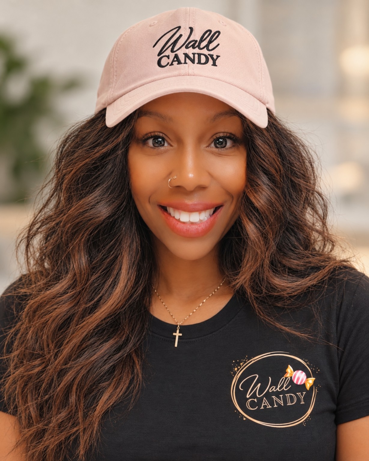Mary Mueller wearing her blush Wall Candy Designs hat and black branded shirt