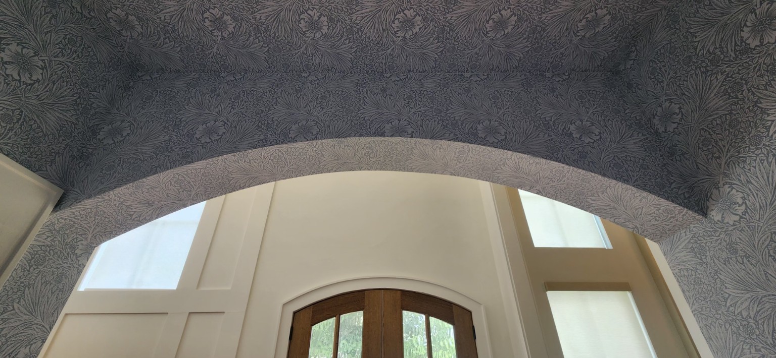 Wallpapered Entry Arch. Detailed wallpaper work fitted around a curved entryway arch.