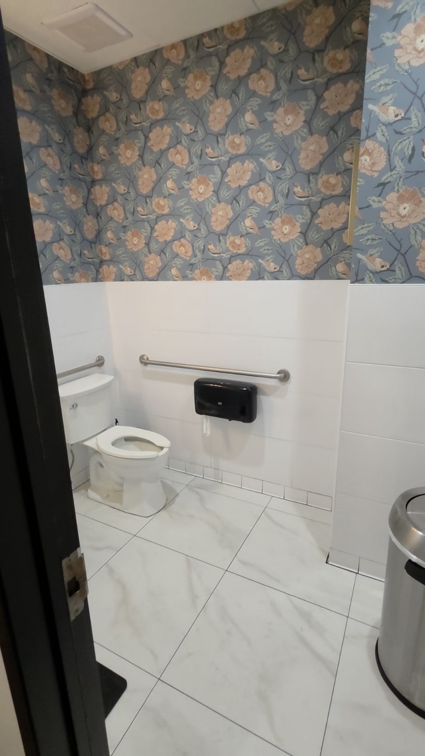 Commercial Floral Restroom. Blue floral wallcovering above tile in a commercial restroom. Updated clearer original photograph.