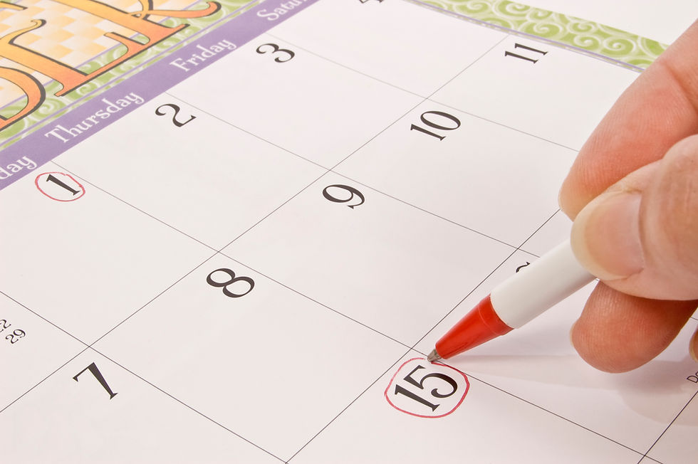 A hand circling a date on a calendar with a red pen, signifying a retirement date.