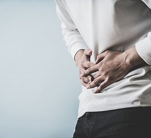 Man holding his stomach indicating stomach pain.