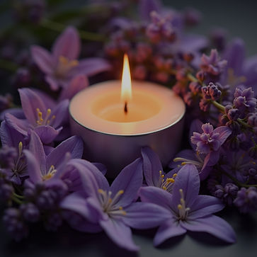 Lit candle with purple flowers
