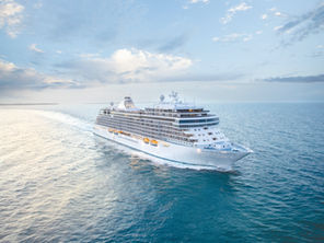 a white ship on pale blue ocean water