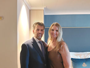man and woman dressed up suit and dress in cruise cabin