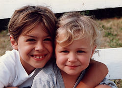 a boy and a girl smiling to depict parent coaching for school-age kids