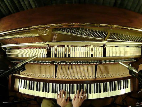 Birdseye view of Justin's hands on his miked piano