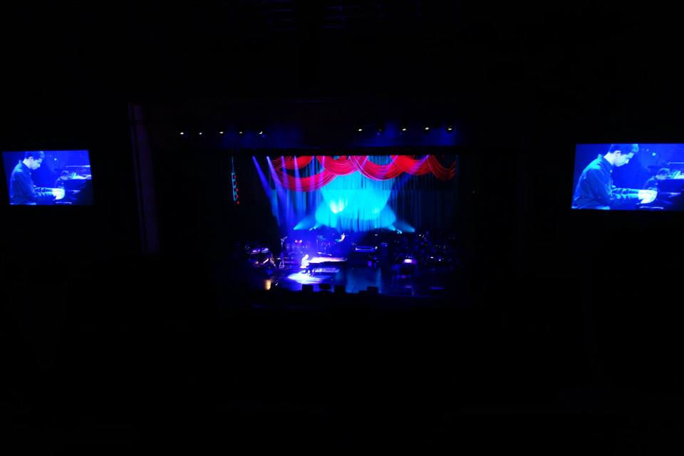 International Forum in Tokyo Japan.  Justin Kauflin on stage, large screens on either side