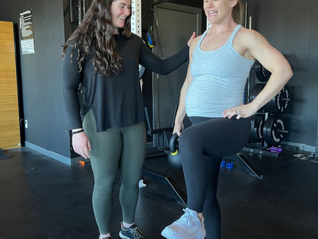 Pelvic floor physical therapist guiding pregnant woman through exercise