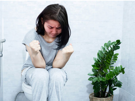 woman straining to have a bowel movement