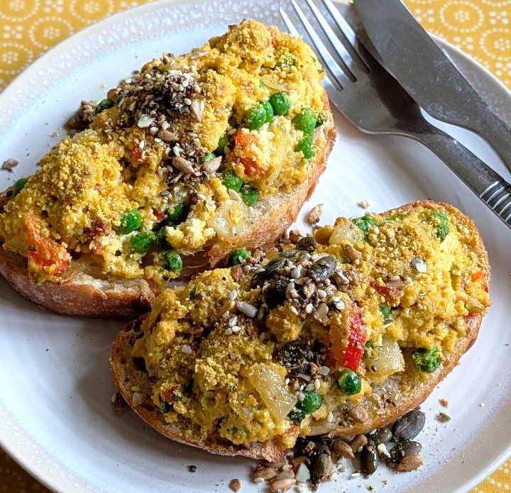 Tofu scramble on toasted sourdough topped with Cashew Parmysan and Sesame Crunch CRUMS