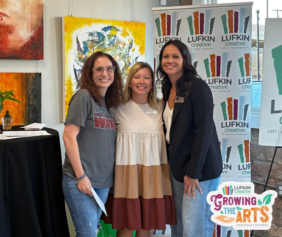 Lufkin Creative board members and Micro Grant recipient standing together at the 2025 Micro Grant Reception, smiling in front of artwork and Lufkin Creative signage.