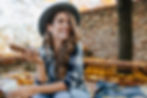 Pretty laughing girl with smartphone has a good time in autumn weekend. Outdoor portrait o