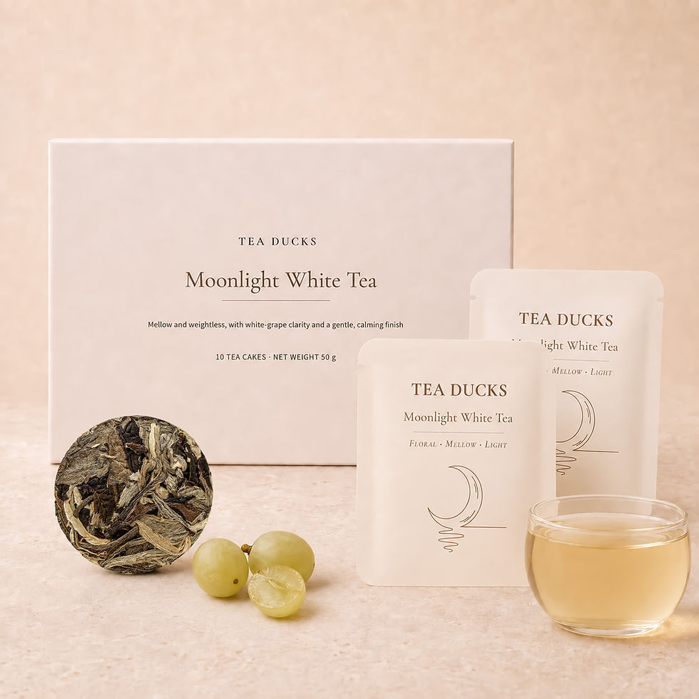 Tea Ducks Moonlight White Tea box with ten 5g compressed white tea rounds, green grapes and pale golden infusion.